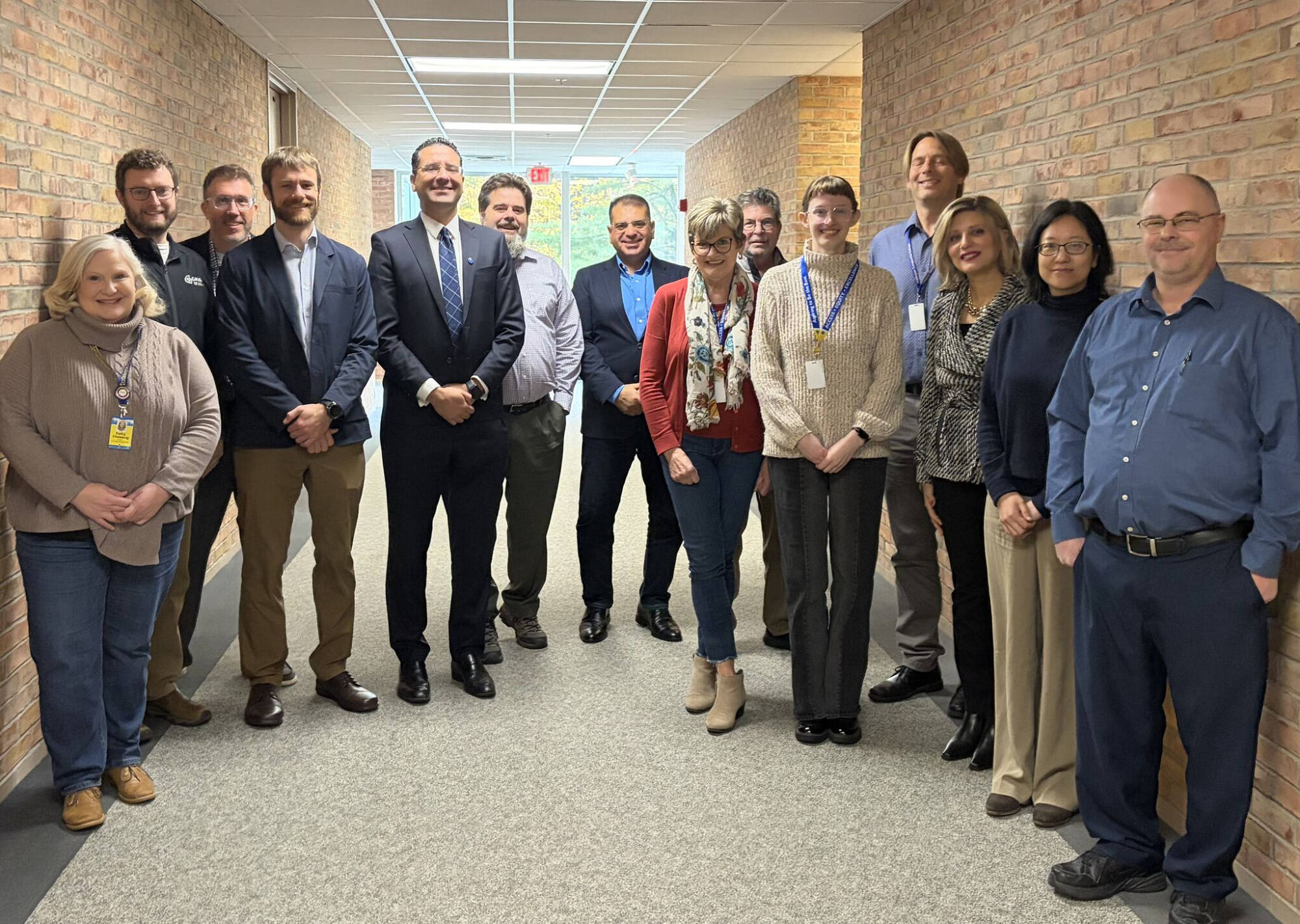 Dean Marouane Kessentini and others from the College of Computing pose with colleagues from Muskegon Community College after discussing an articulation agreement.